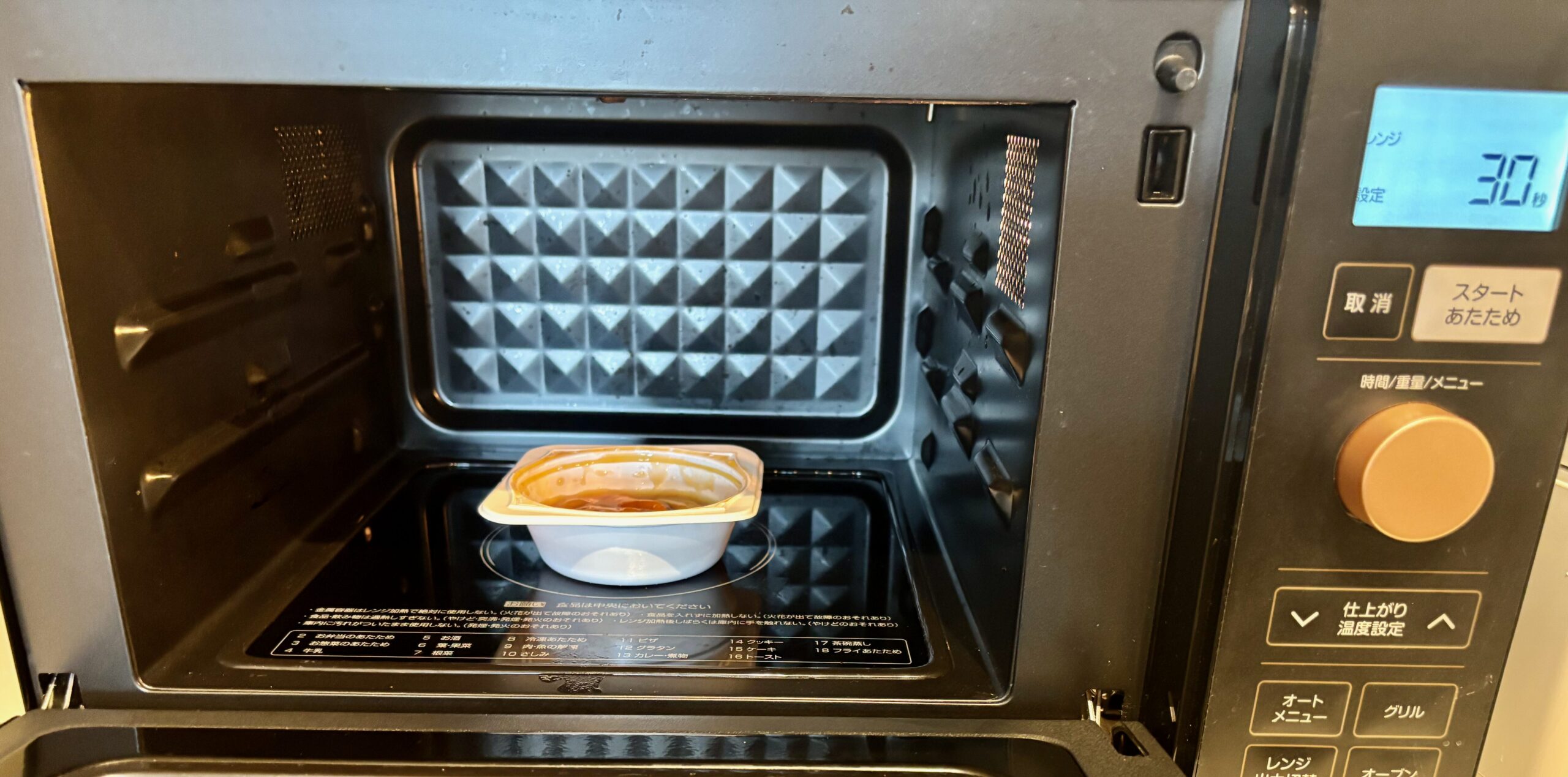 エバースマイル 白身魚の煮つけを電子レンジに入れている写真