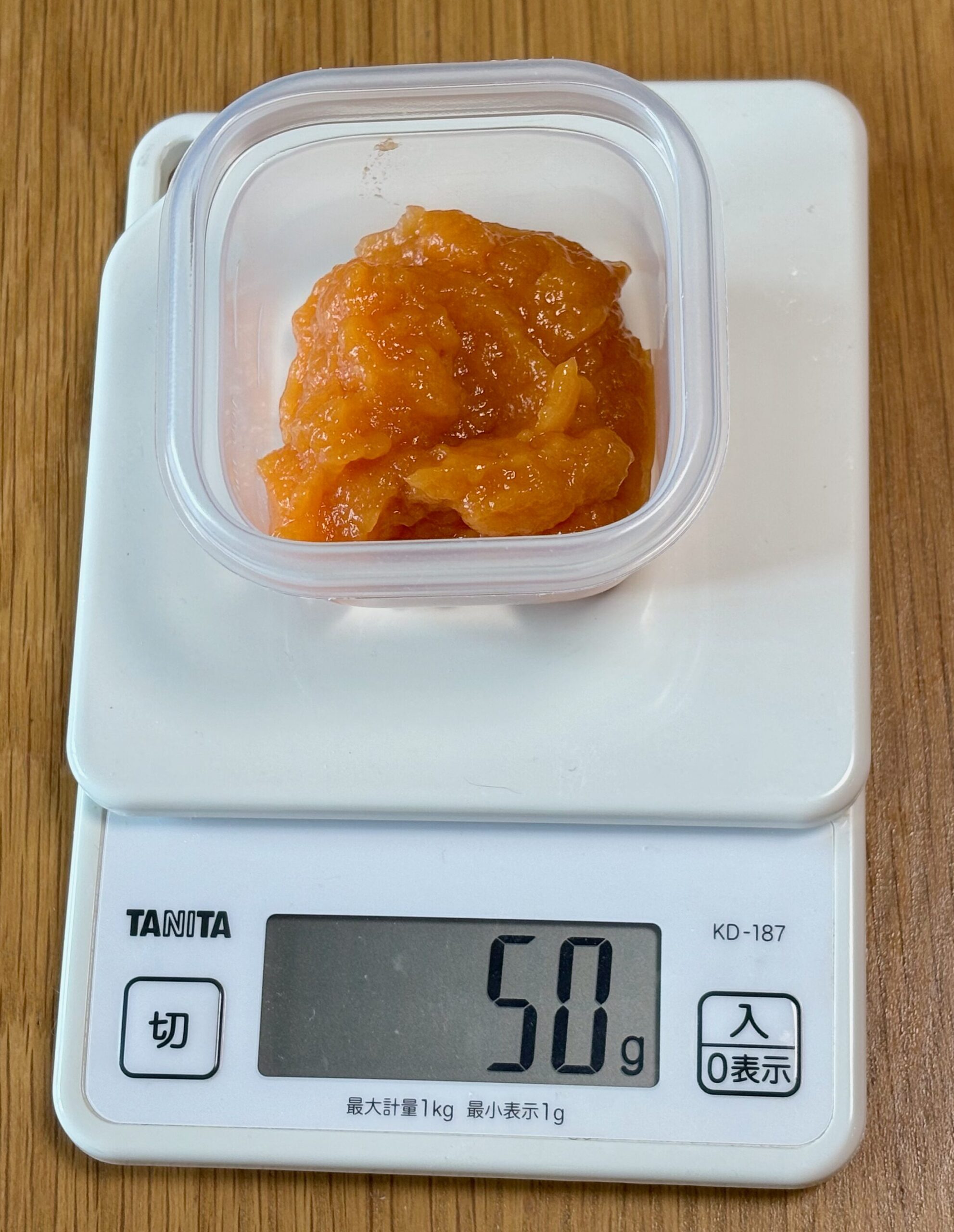 保存する容器に取り分けたにんじんのムース食50gをはかっているところ